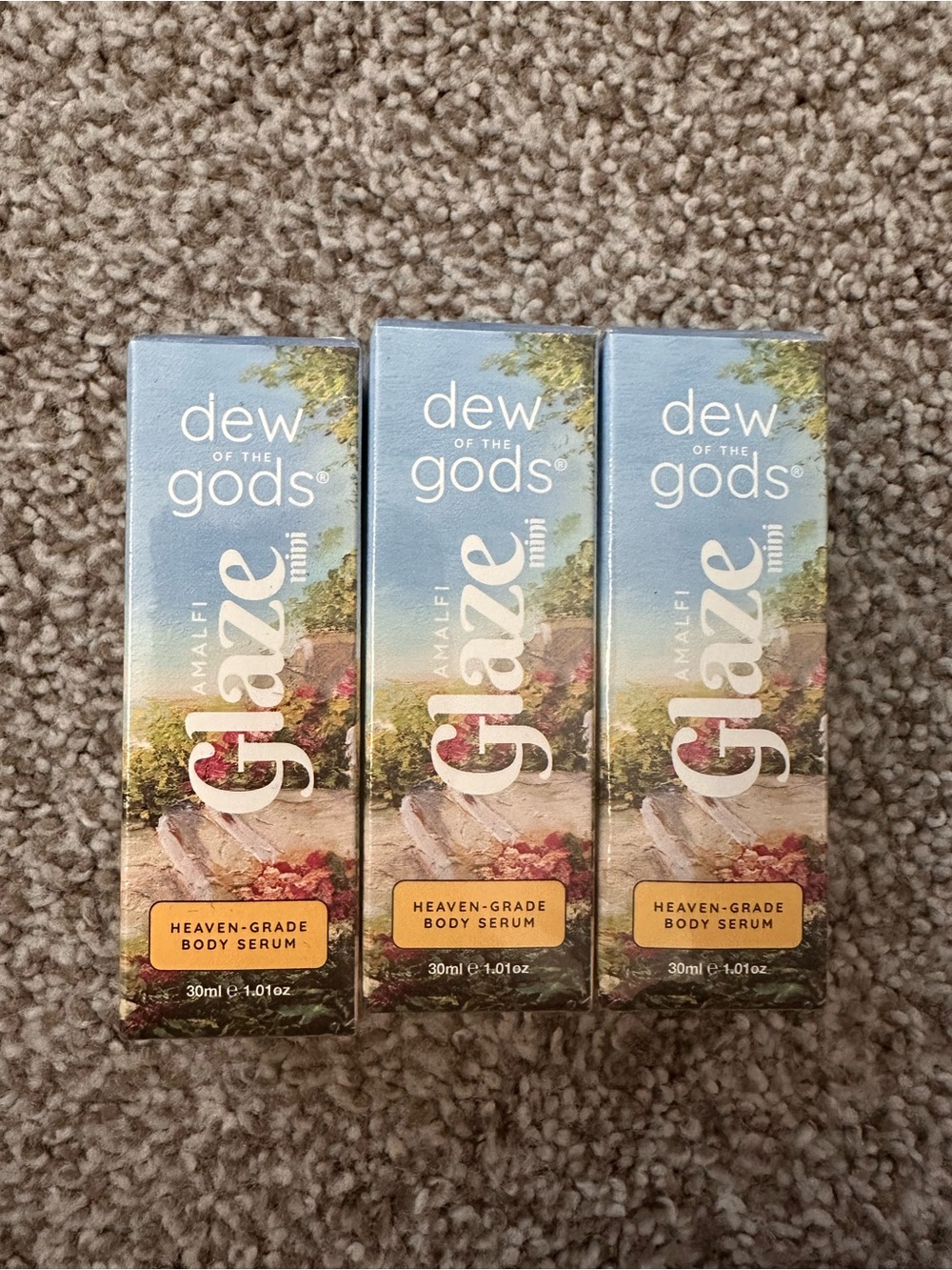 Glaze Dew of the Gods Body Serum Boxes in Blue and Cream Packaging